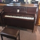 brown upright piano with bench made by hallet davis