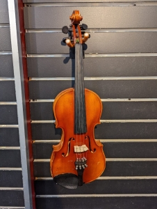 3/4 violin hanging on a slatted wall