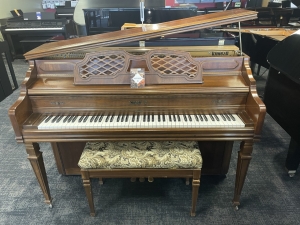 front view of brown upright piano