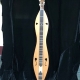 lap dulcimer standing up with black background