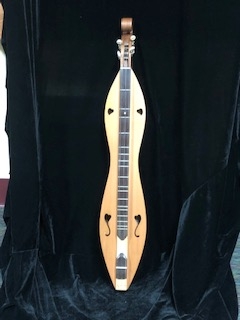 lap dulcimer standing up with black background